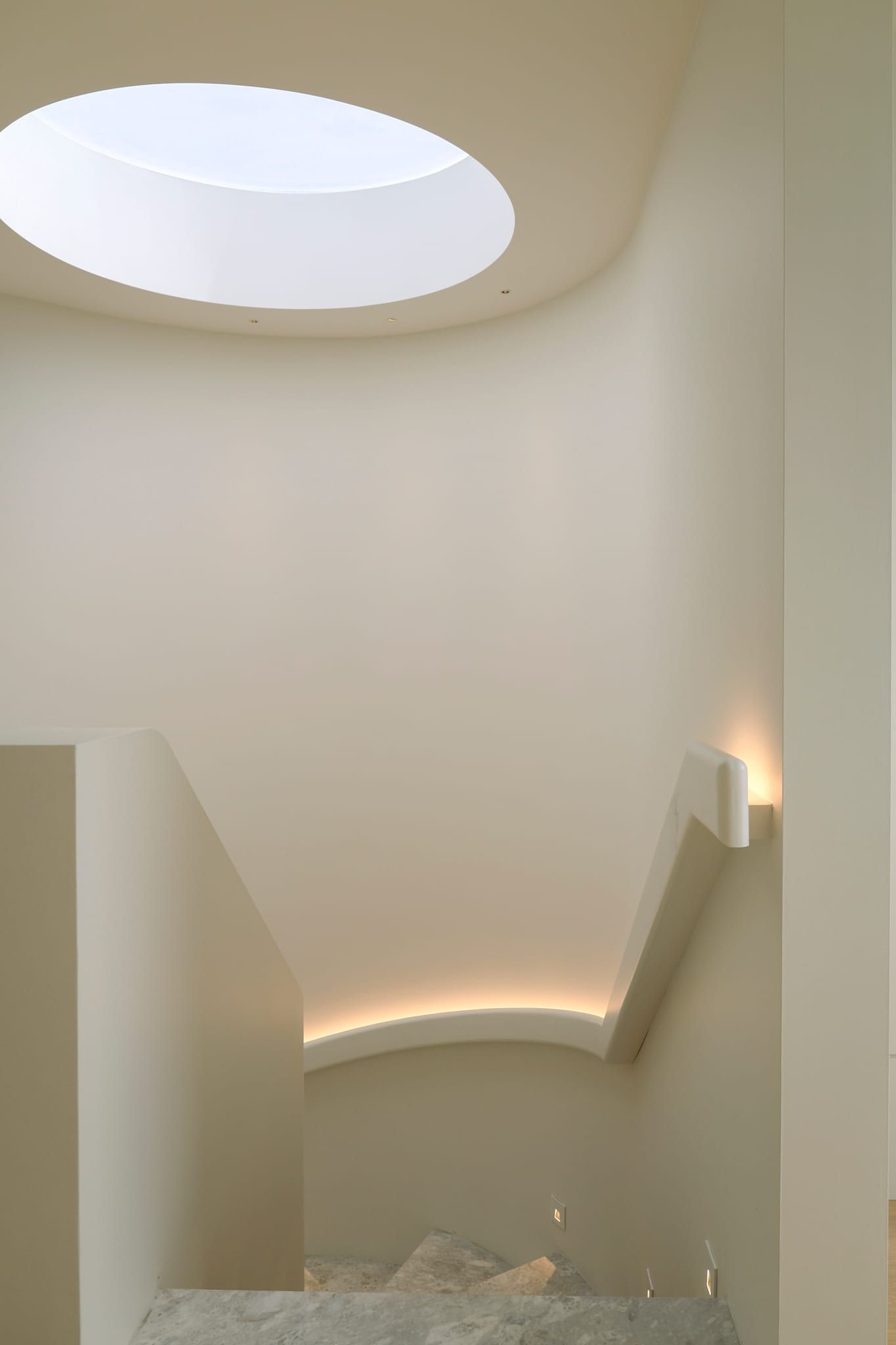 The domed, cove-lit ceiling above the stair