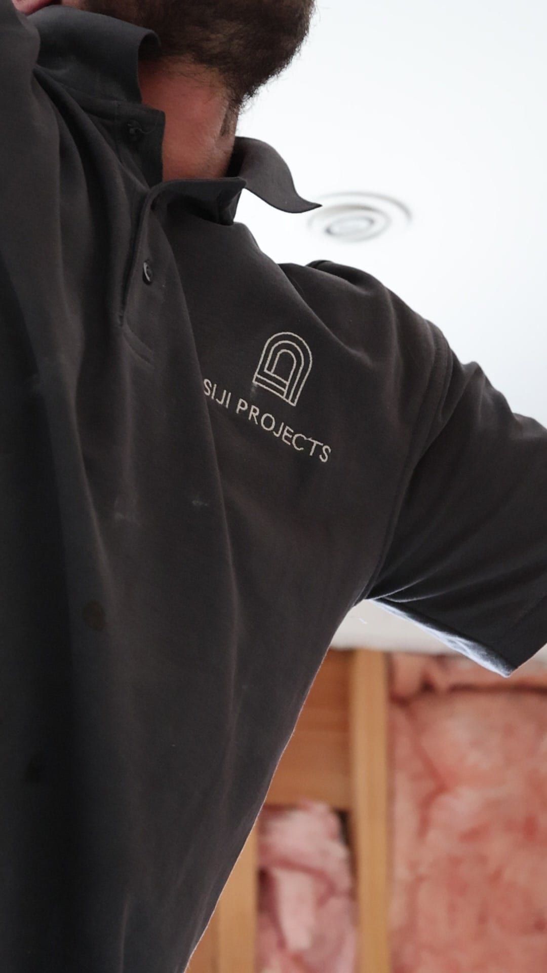 A member of the Siji Projects crew on site in a branded polo