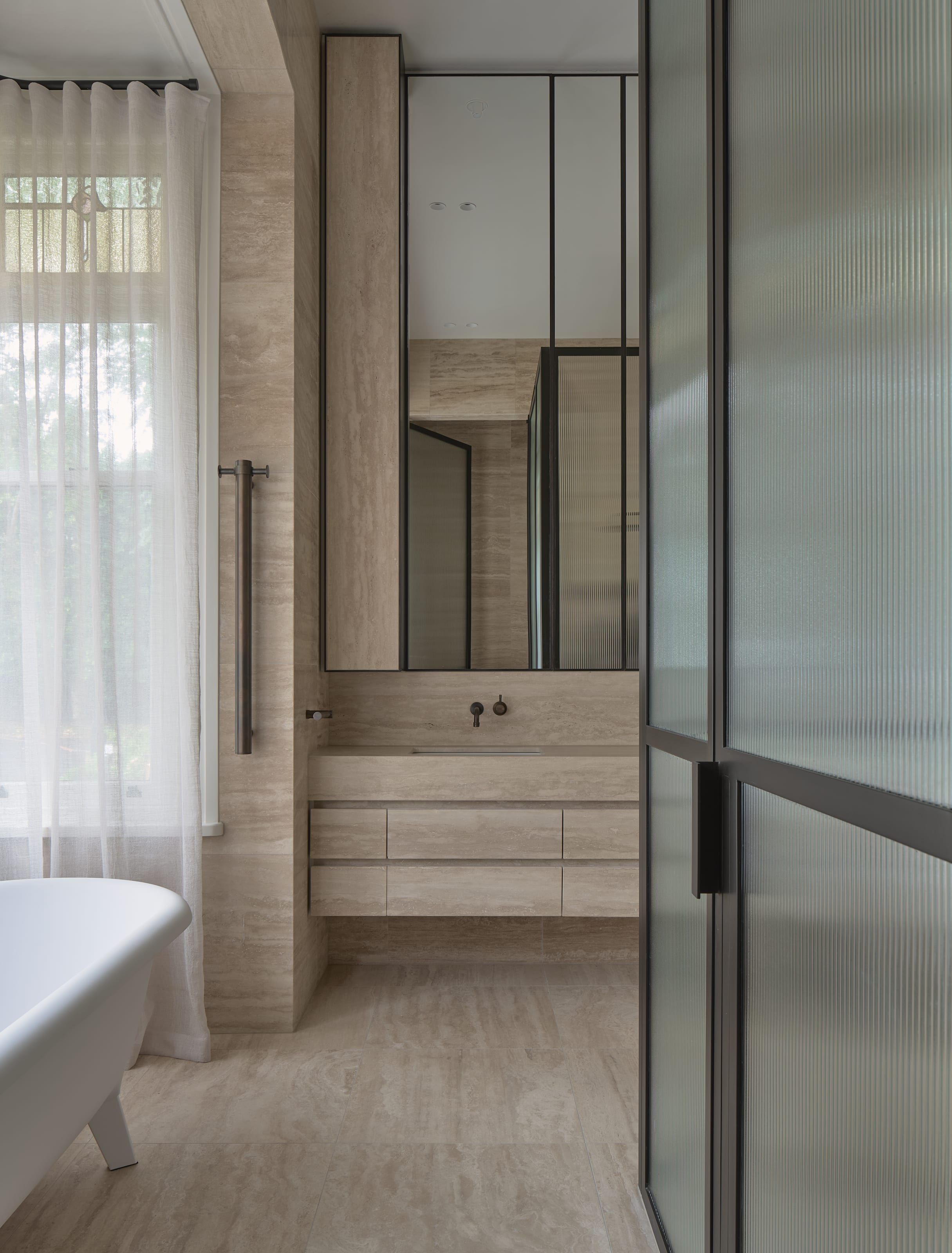 Bathroom with full-height stone and timber joinery