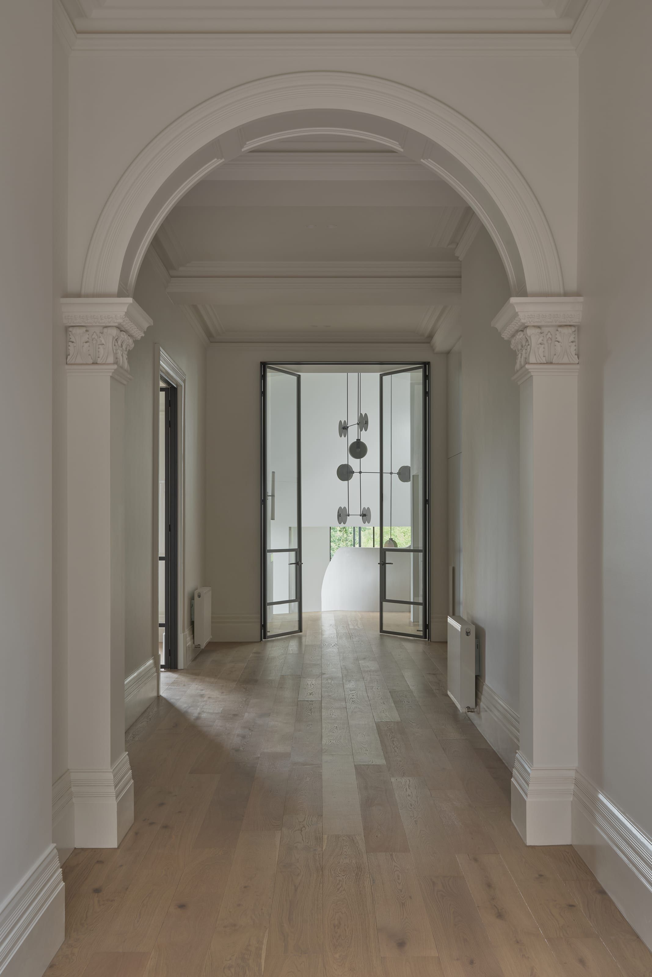 Steel-framed glazed doors set within restored masonry arches