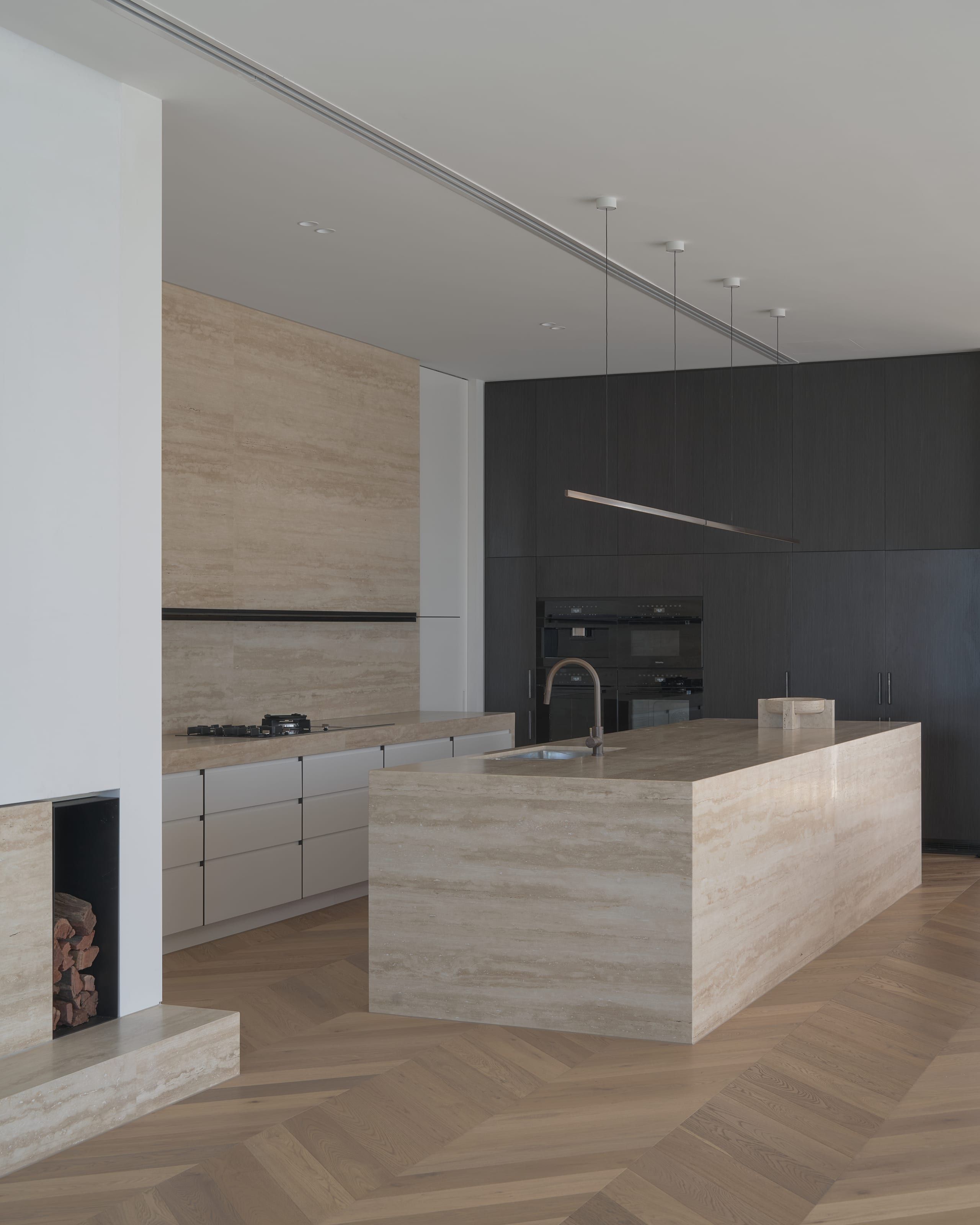 Kitchen joinery in pale timber with stone benchtops