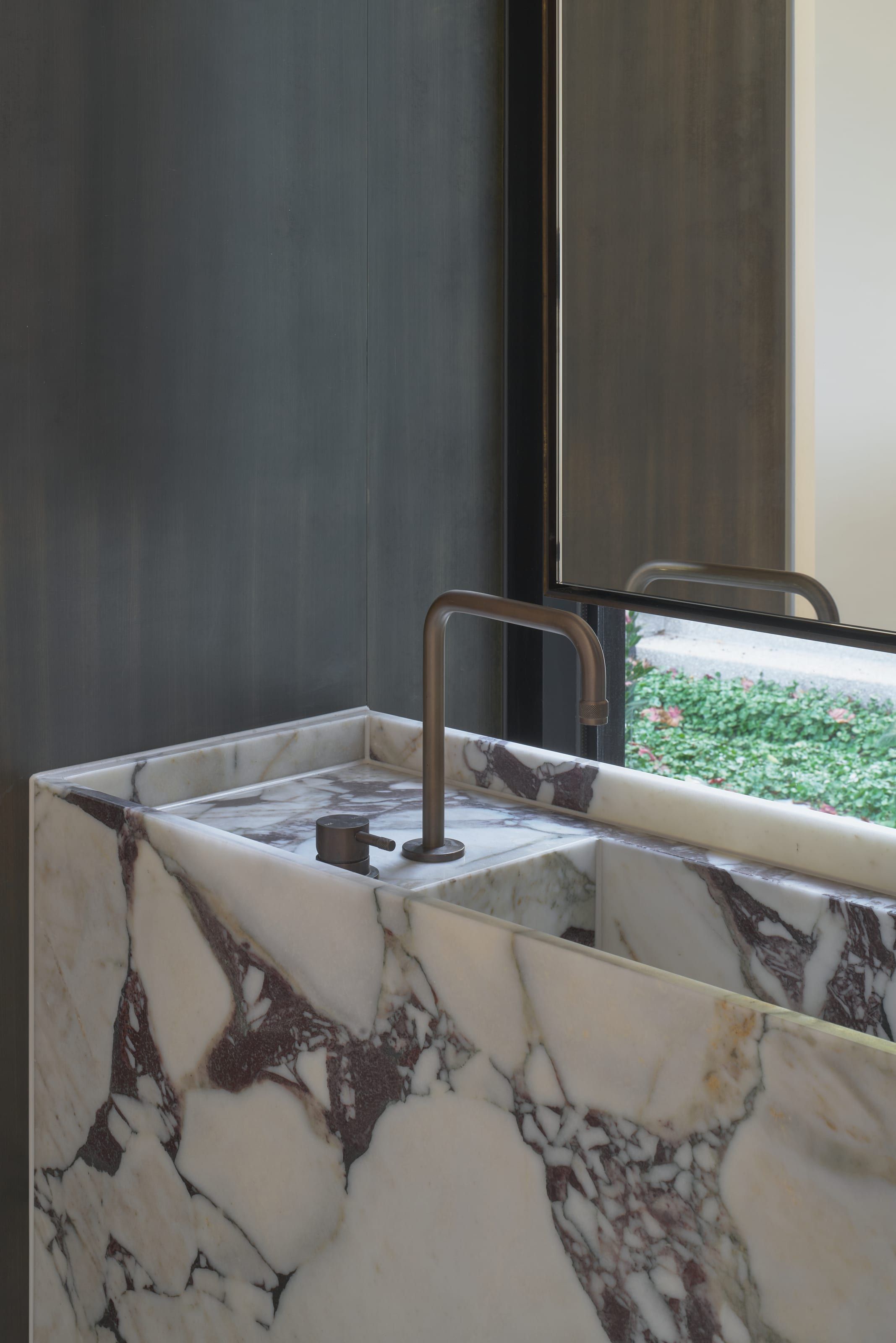 Vein-matched stone benchtop and tapware detail in the butler's kitchen